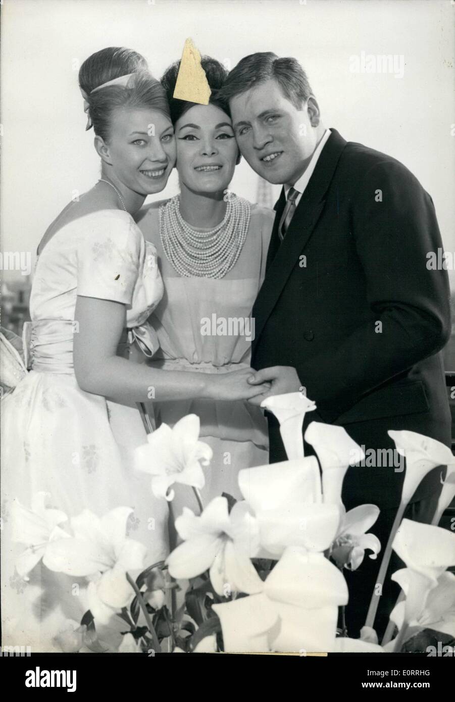 May 05, 1960 - Lucky's Daughter to wed:Eighteen Year old Michele Luck's Daughter, will Mary Jean Louis Solminac, 26 who runs with his father a big transport n company. Lucky, one of the leading and best known French Haute Couture Mannequin announced her daughter's engagement today. Photo shows Lucky (centre) pictured with her daughter Michele and Michele's Fiance Jean, Louis Solminac. Stock Photo