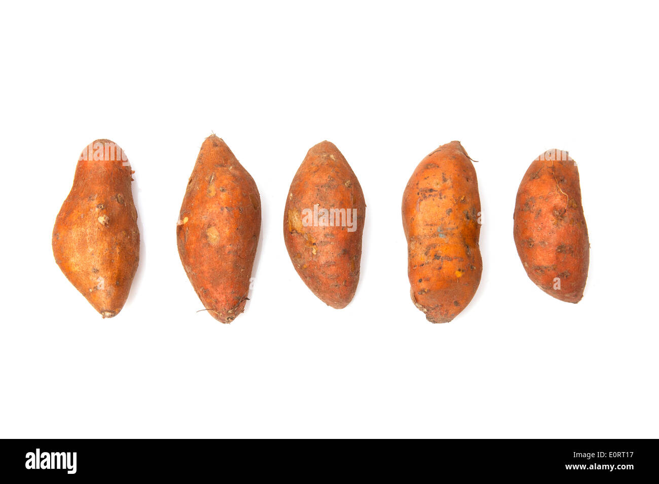 Sweet Potatoes isolated on a white studio background. Stock Photo