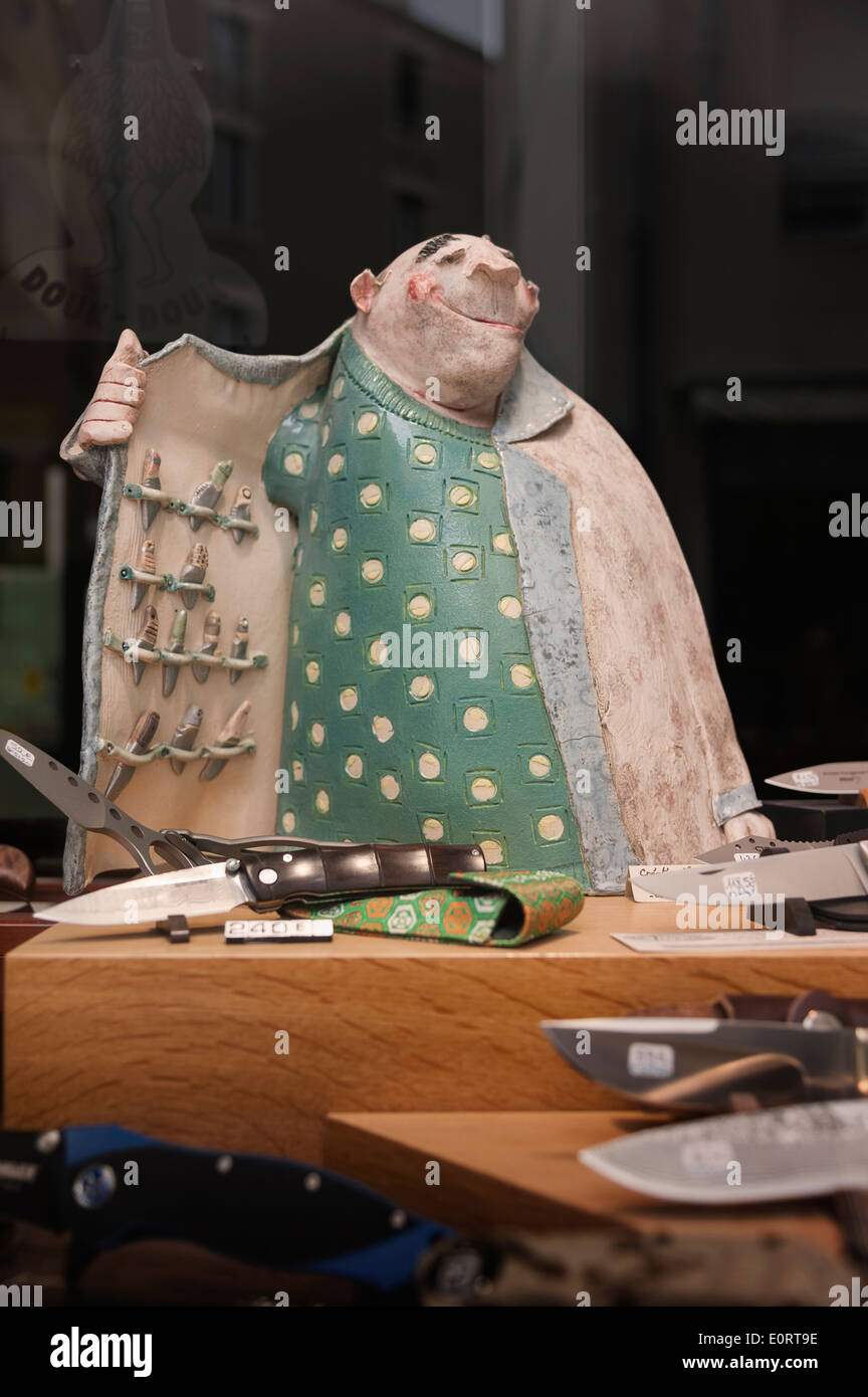 Statue of a rogue knife trader or seller in the shop window of a knife store Stock Photo