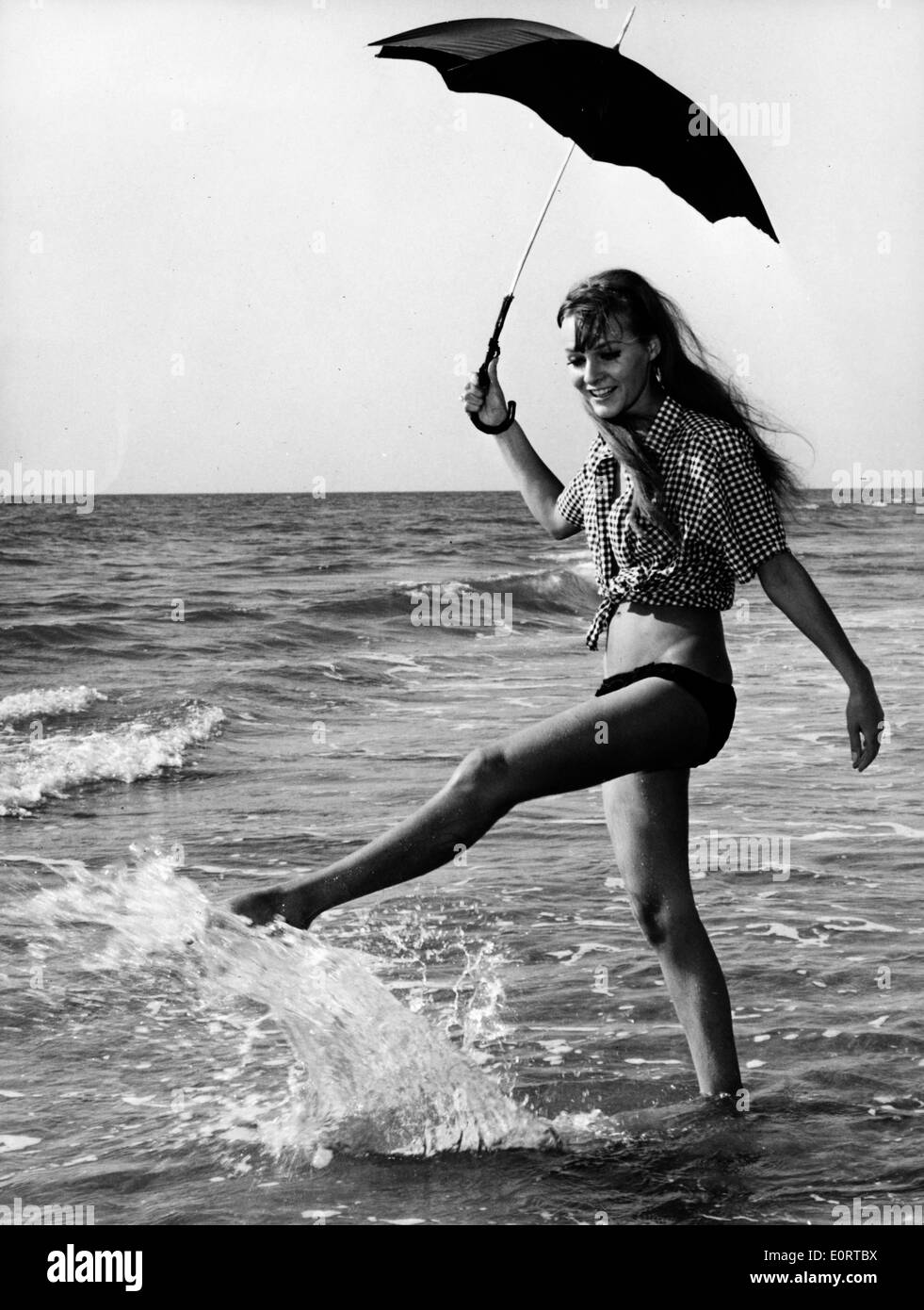 Portrait of Heidi Fischer splashing in the waves at the beach Stock Photo
