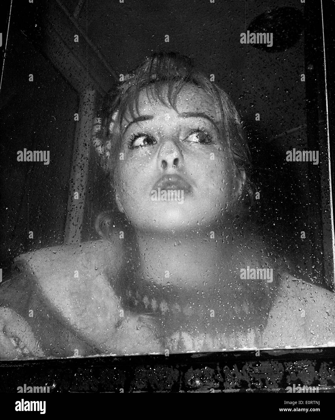 Actress Mylene Demongeot makes face on glass Stock Photo