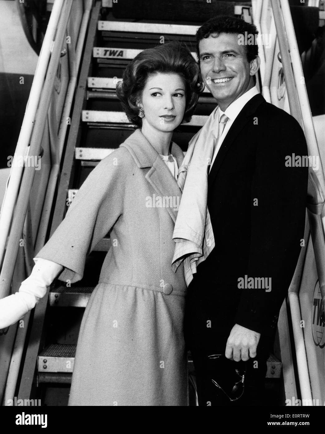 Actor Tony Franciosa boarding an airplane with a woman Stock Photo