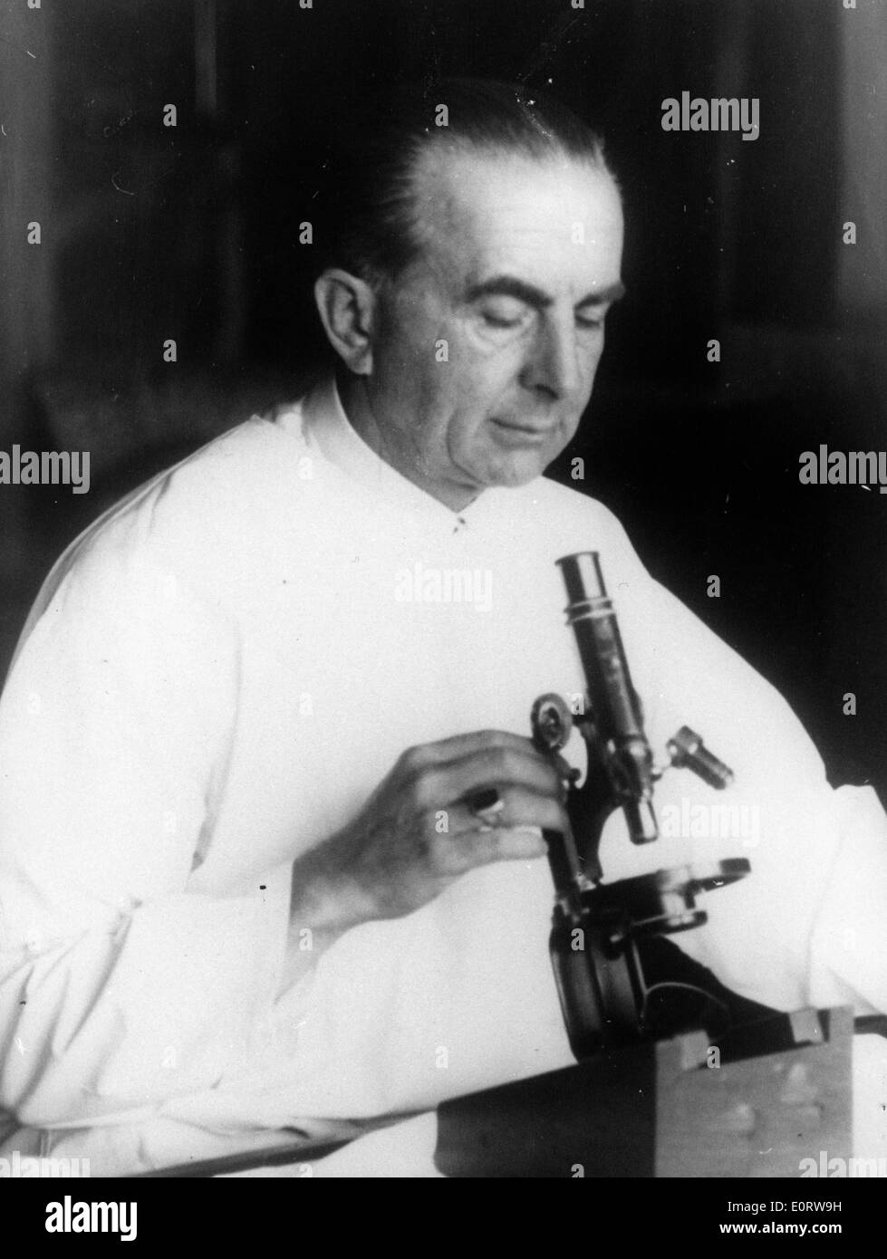 Dr. Eduard Albert Fisch works with microscope Stock Photo
