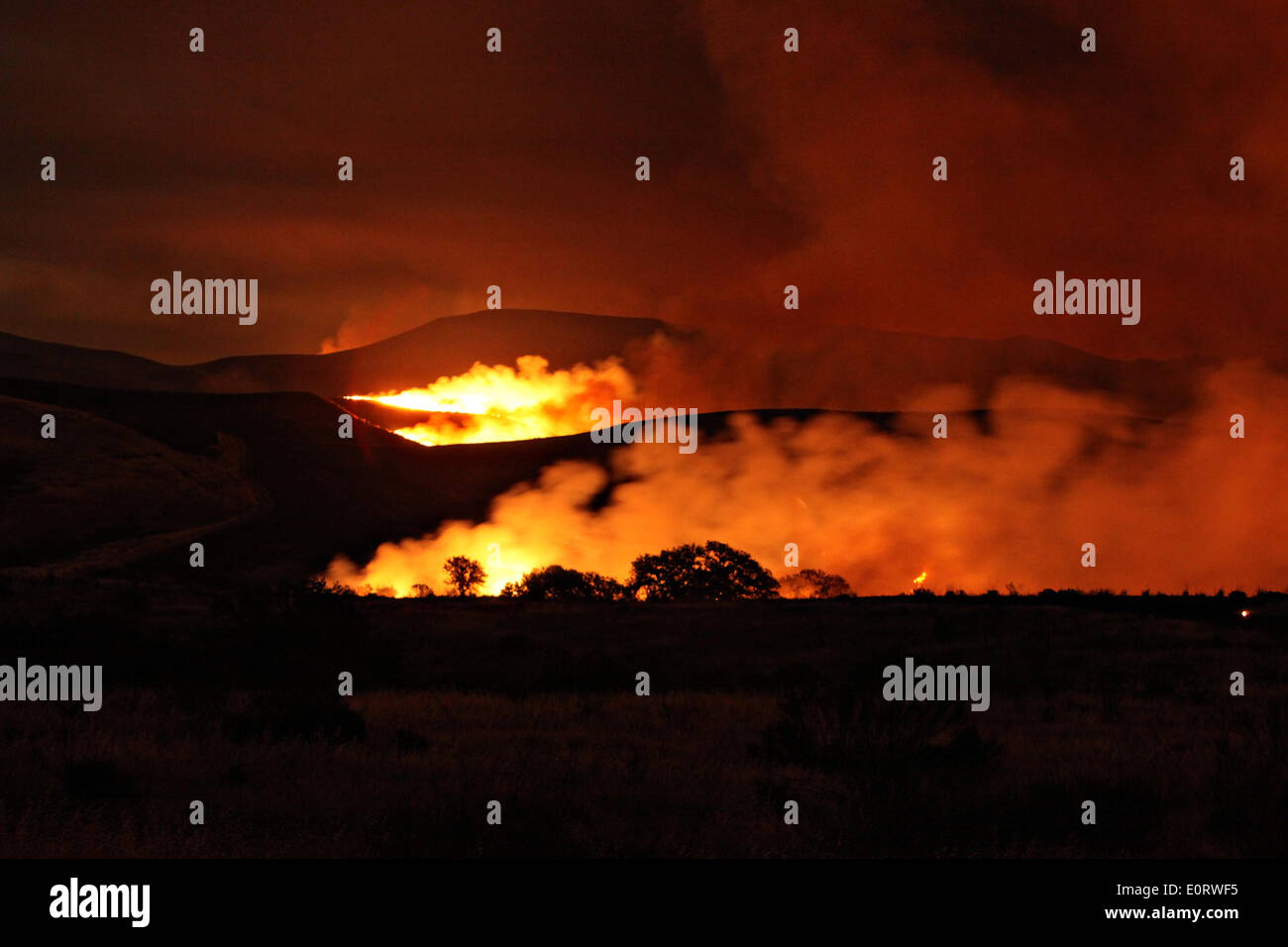 The Las Pulgas and Tomahawk wildfire burns at night in the foothills around the Marine Corps base May 15, 2014 in Camp Pendleton, California. Stock Photo