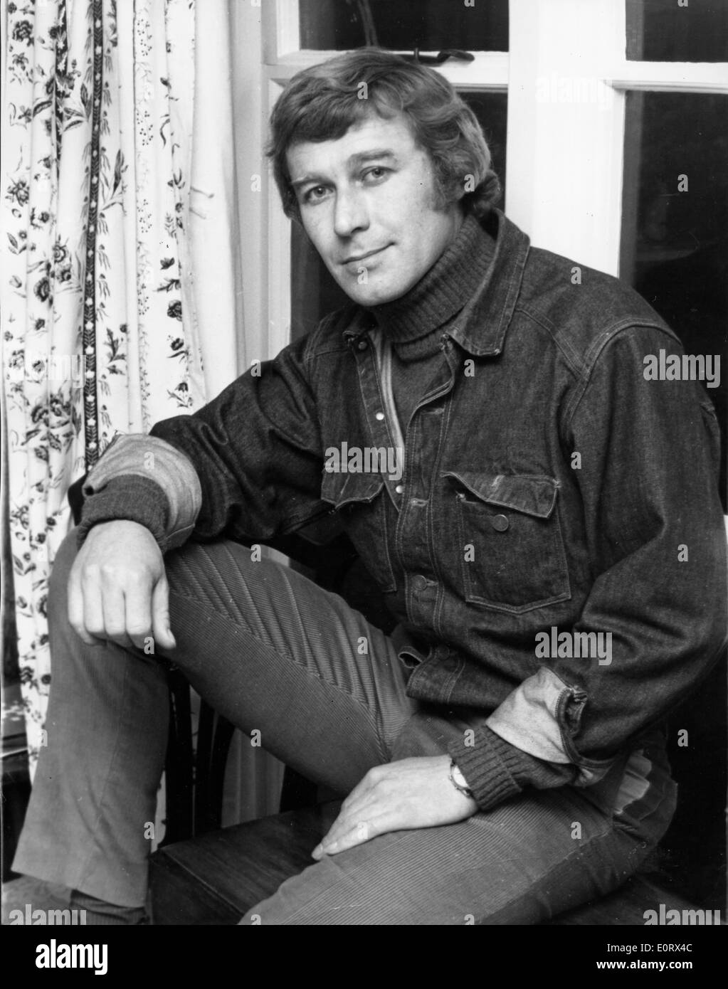 Actor Errol Flynn on window sill at young age Stock Photo