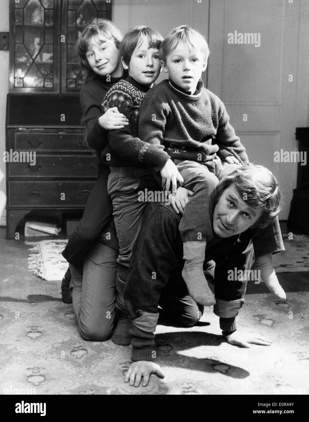 Actor Errol Flynn and kids in a film scene Stock Photo