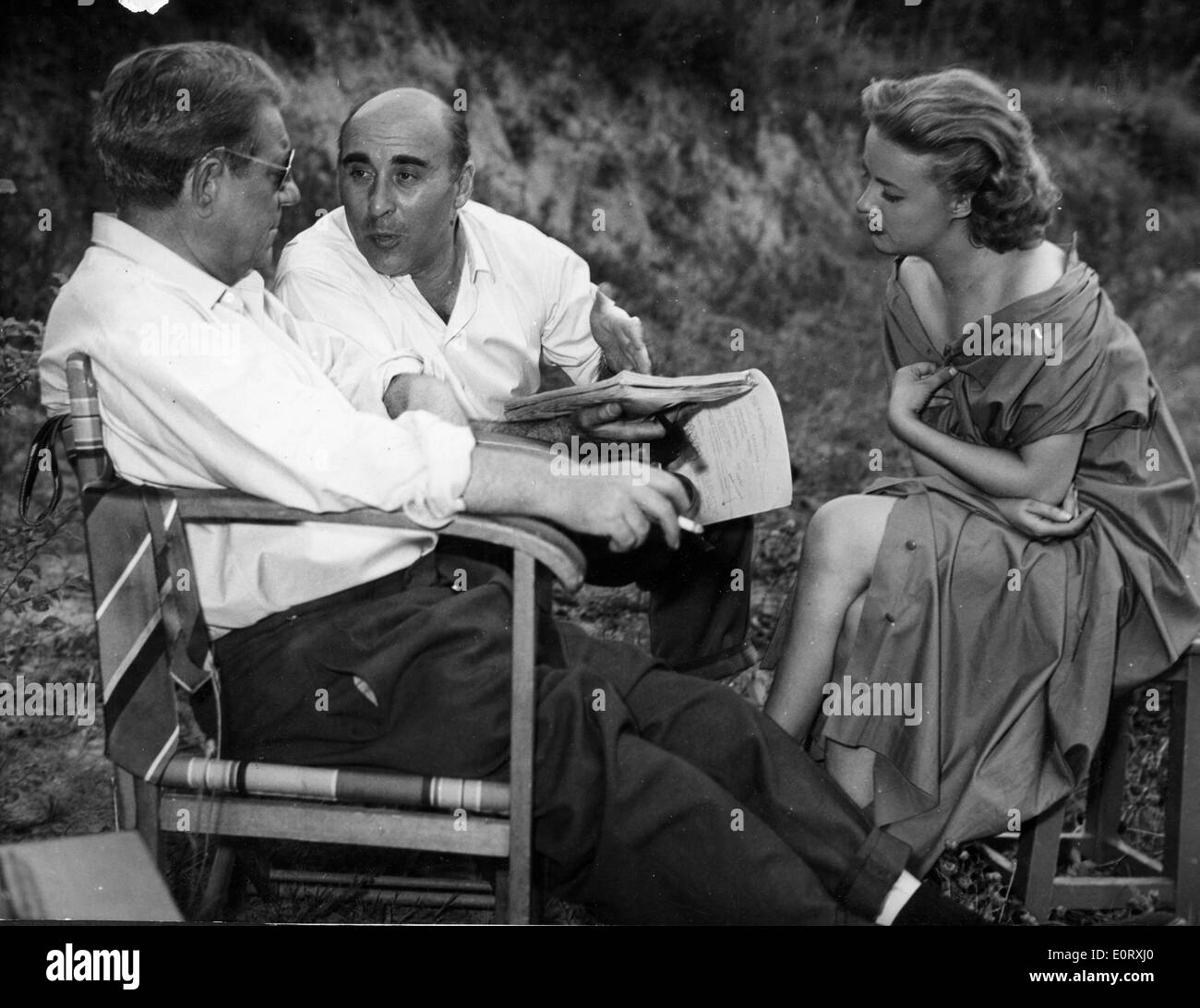 Actor Jean Gabin and co-stars talk on film set Stock Photo