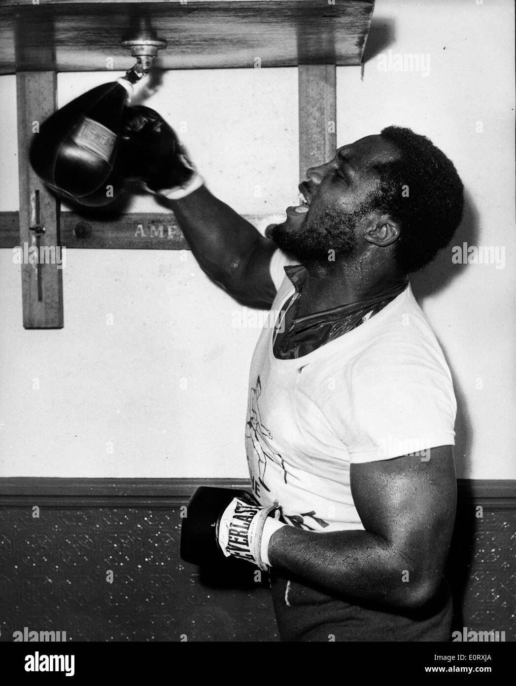 Smokin' Joe Frazier at gym hitting a punching bag Stock Photo