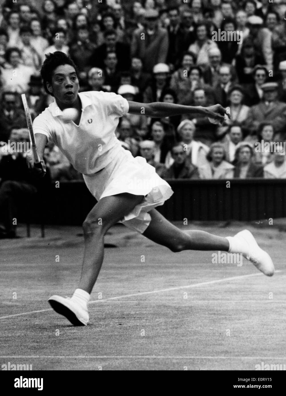 Tennis pro Althea Gibson goes after ball during match Stock Photo