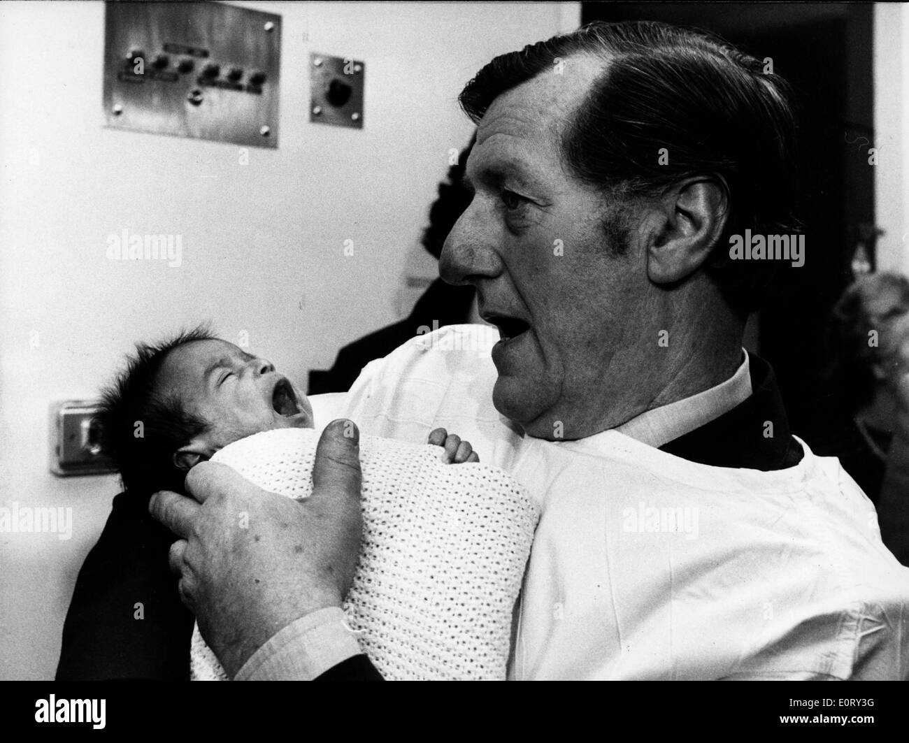 Politician David Ennals holds his newborn child Stock Photo