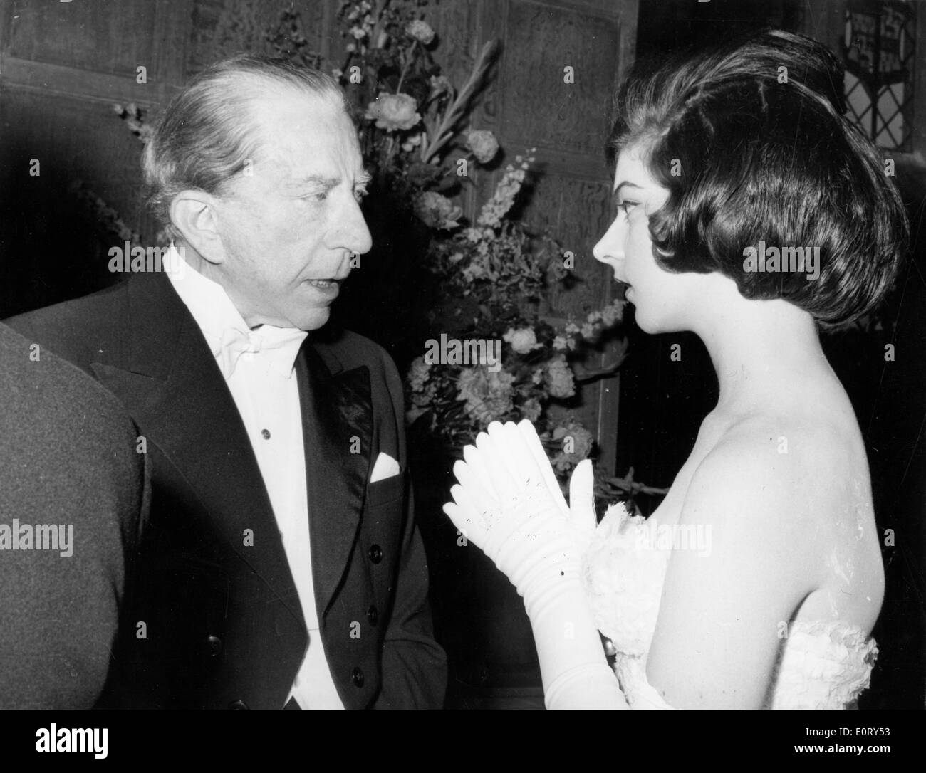 Industrialist J. Paul Getty talks with woman at party Stock Photo