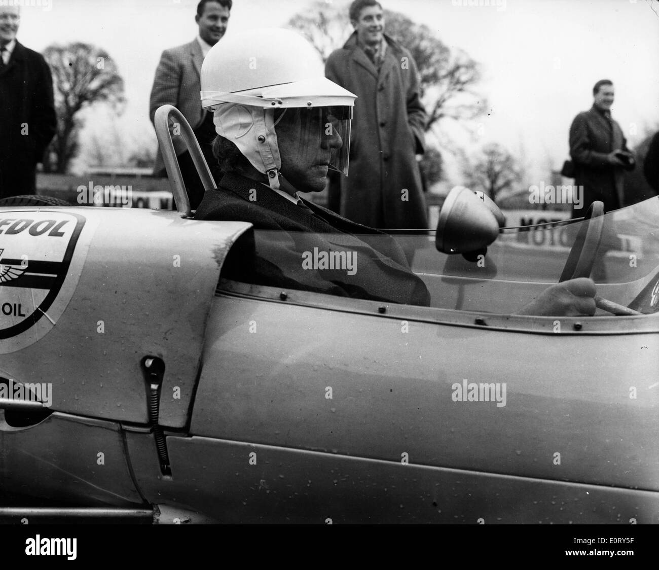 Industrialist J. Paul Getty drives racecar Stock Photo