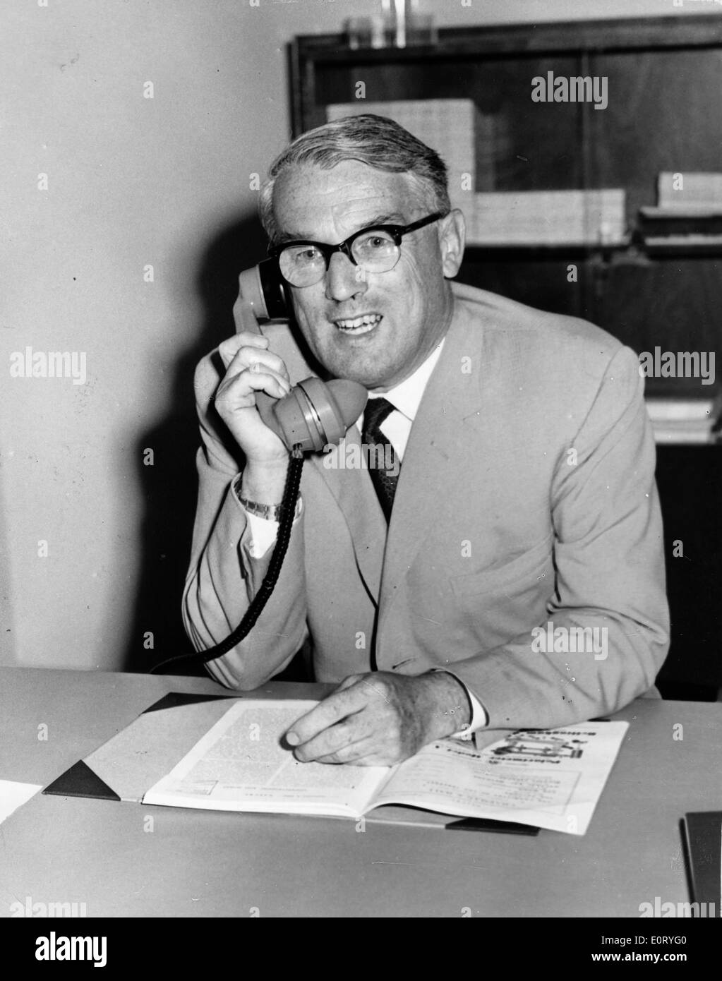 Director D.W. Fry on the phone in his office Stock Photo