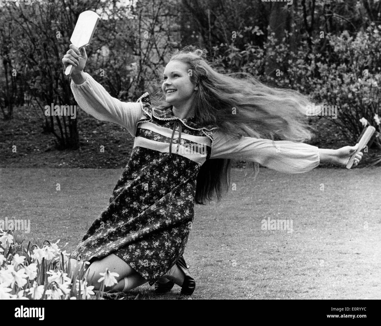 Actress Fiona Fullerton brushing her hair in the garden Stock Photo