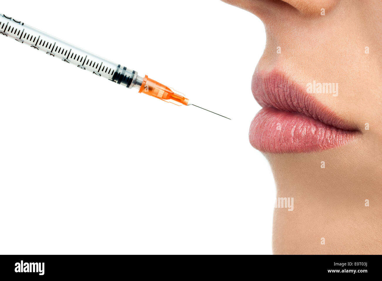 Macro close up of botox syringe and female lips.Isolated on white background. Stock Photo