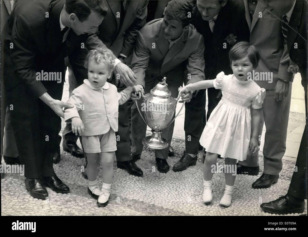 May 18, 1960 - What kind of toy is it?: Little Prince Albert and his sister Princess Caroline, children of Prince Rainier and Princess Grace of Monaco, look somewhat bewildered as footballers of the Monaco team put into their hands the cup final trophy they won in Paris last Sunday. Stock Photo