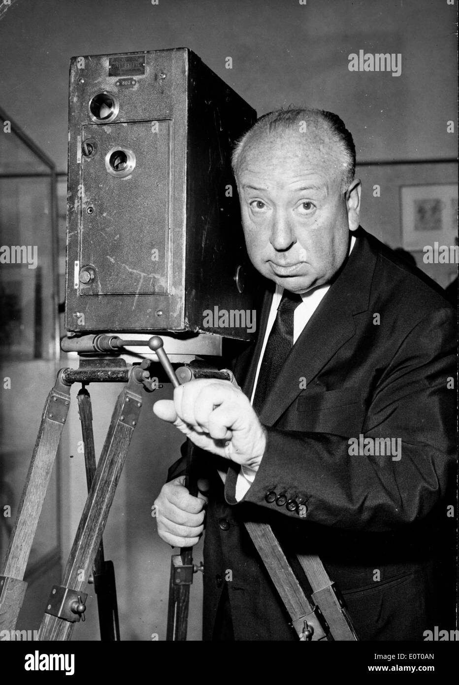 Film maker Alfred Hitchcock standing with a camera Stock Photo