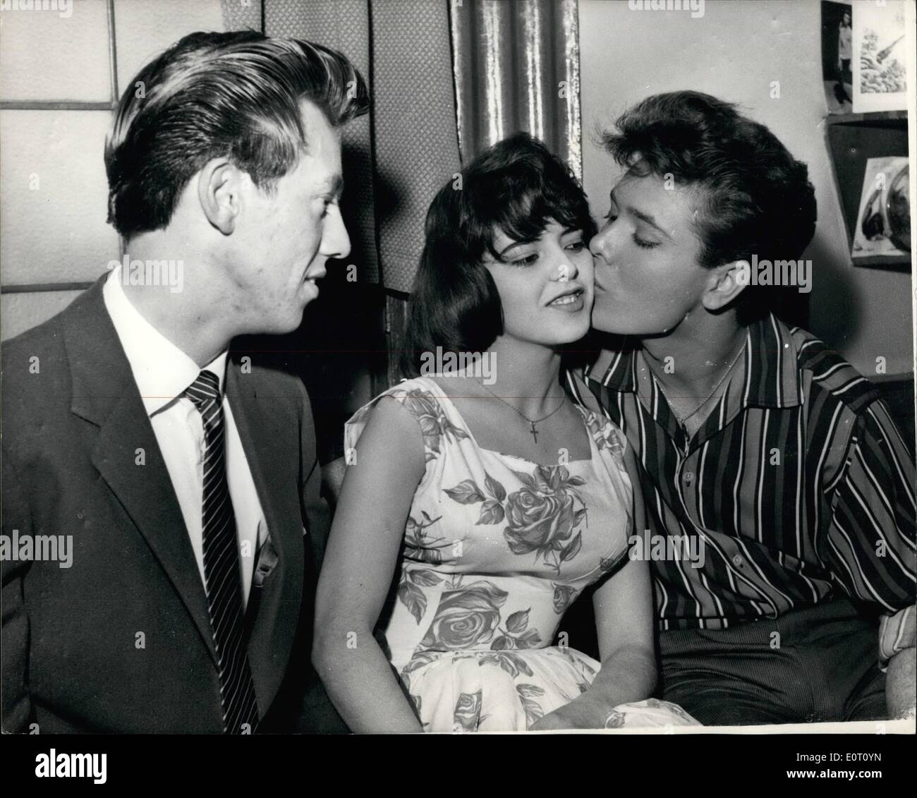 Jun. 06, 1960 - seventeen-year-old sister of rock-'n' roll star becomes engaged : 17 year-old Donella Webb, the ister of the famous rock 'n' singer, Cliff Richards, this evening announced her engagement to 20-year-old Paul Stevens, of waltham abbey. No date has yet been fired for the wedding. Paul is a van-driver. photo shows A congratulatory kiss from Cliff richards for his sister Donella watched by her finance paul in the dressing room of cliff richards' this evening. Cliff is at present appearing in the show ''Stars in your eyes'' at the London palladium. Stock Photo