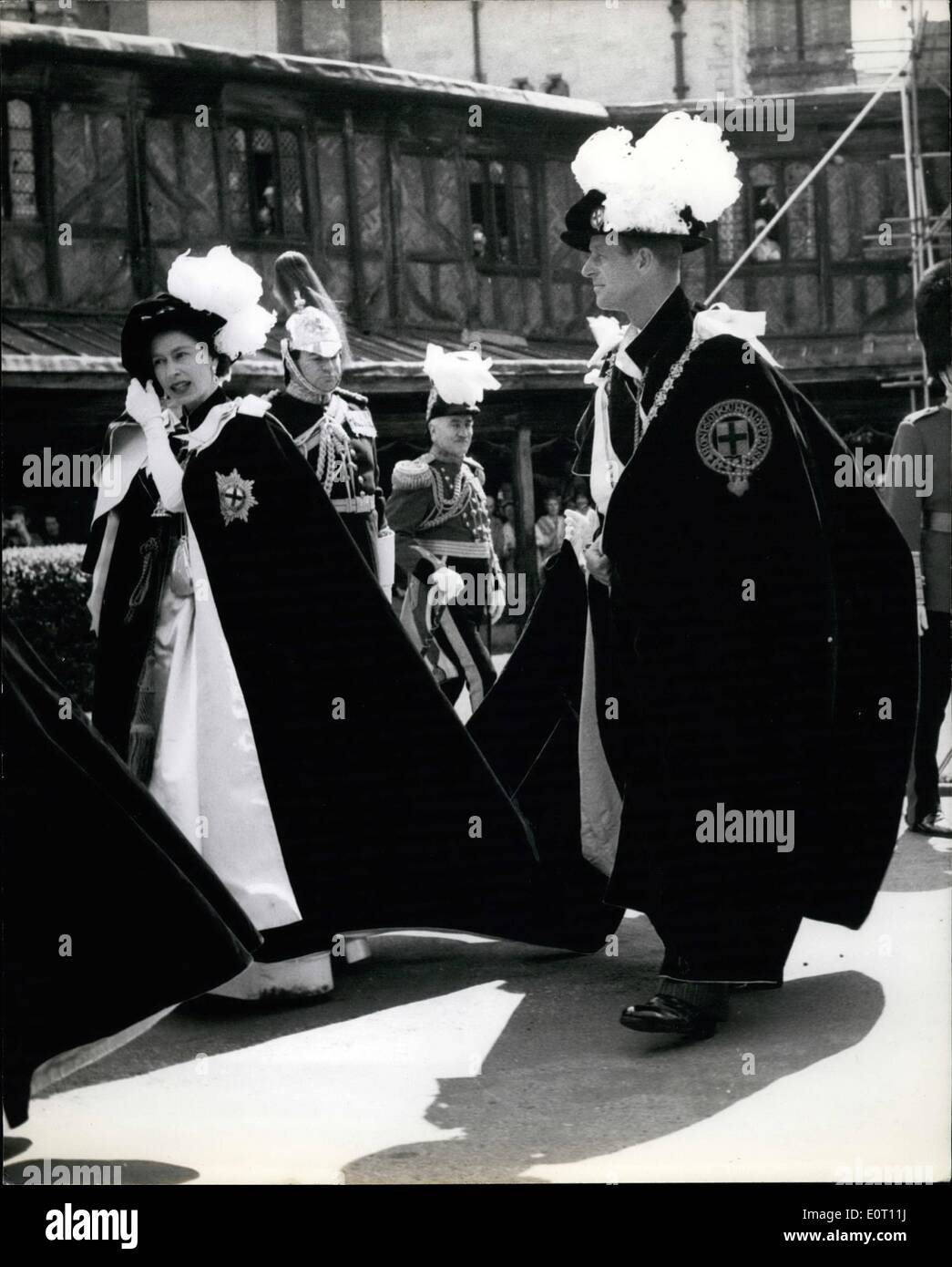 Jun. 06, 1960 - Ceremony of the Garter - at Windsor. Queen holds on to her hat.: H. M. the Queen officiated at the ceremony of the Garter at Windsor this afternoon - when four new Knights Commander were initiated. They were field marshal Sir William Slim; Duke of Northumberland; Earl of Radnor and Lord Digby. Photo shows H. M. the Queen holds her Hat in the breeze - as she arrived at the West Door with the Duke of Edinburgh - for the ceremonies. Stock Photo