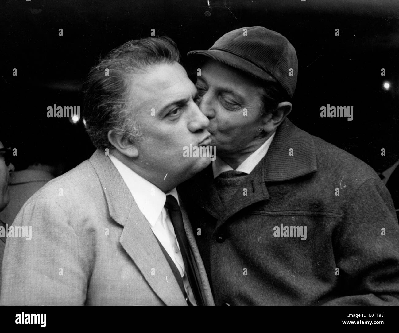 Director Federico Fellini gets kissed on the cheek Stock Photo