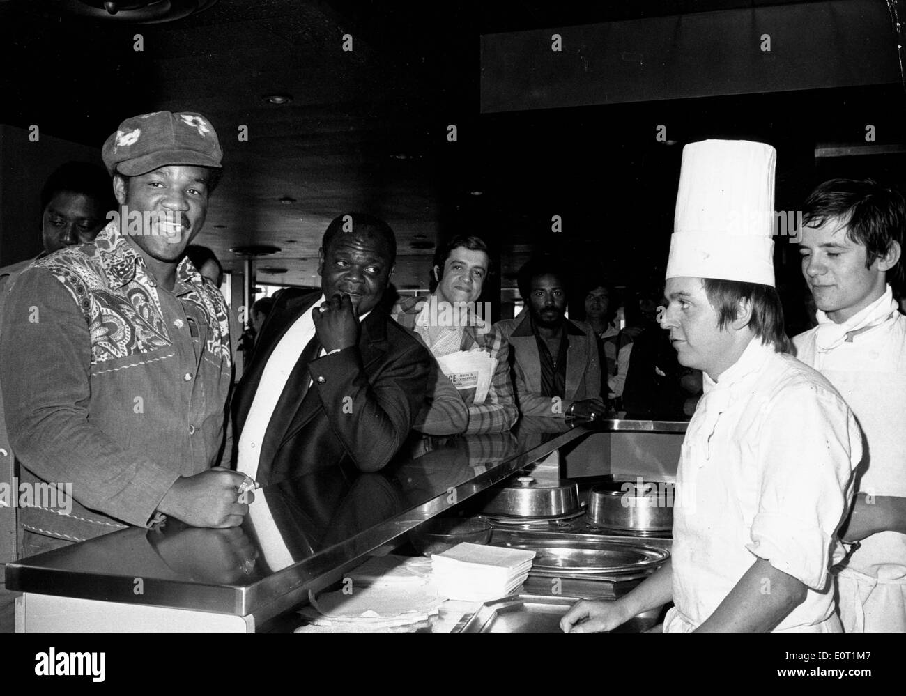 Boxer George Foreman talking with chef at restaurant Stock Photo