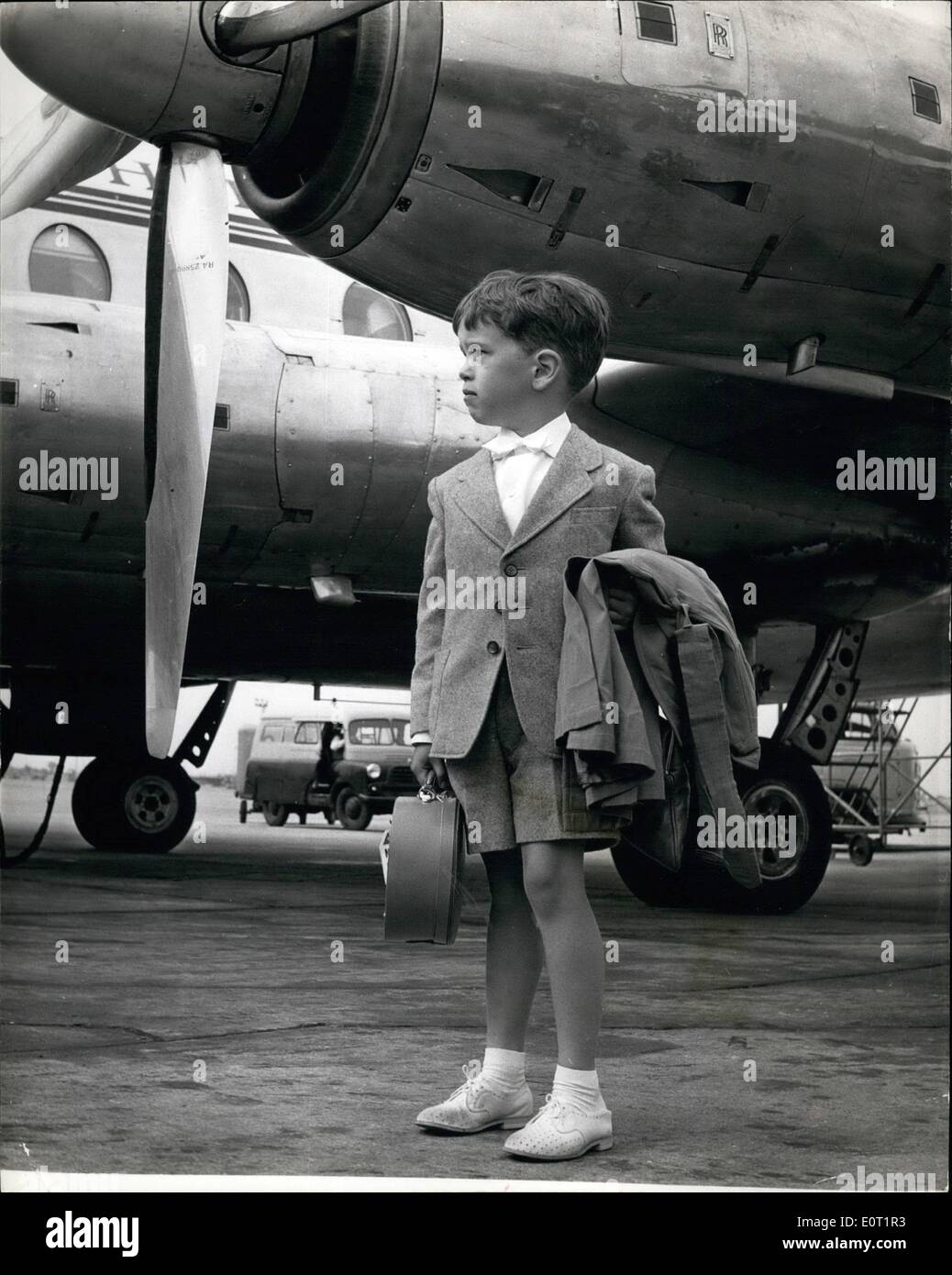 Jul. 07, 1960 - Members of Charlie Chaplin's family arrive in London: Four members of Charlie Chaplin's family arrived in London yesterday en route for Ireland for a holiday. Photo shows Eugene Chaplin who is called ''Tadpole'' by the family stands waiting for other members of his family beneath the engines of one of the aircraft at London Airport. Stock Photo