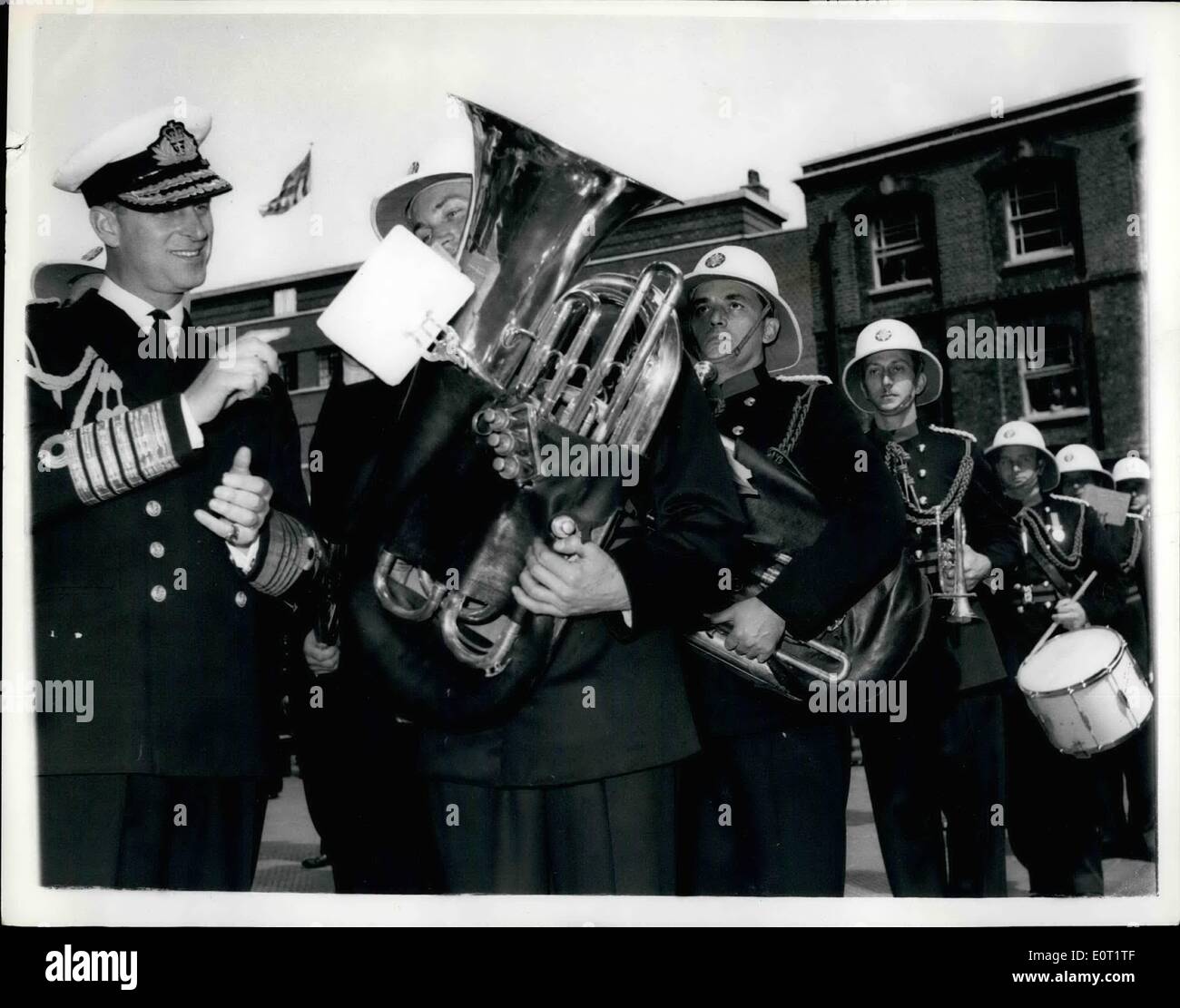 Jul. 07, 1960 - Duke of Edinburgh inspects the London Fire Brigade: H.R.H. The Duke of Edinburgh yesterday paid a visit to the Headquarters of the London Fire Brigade where he saw a demonstration of the latest methods of fire combat etc.. Photo shows The Duke asks Tuba Player G. Whybrow what piece of music he was playing and received the answer ''Old Father Thames'' during the Duke's visit yesterday. Stock Photo
