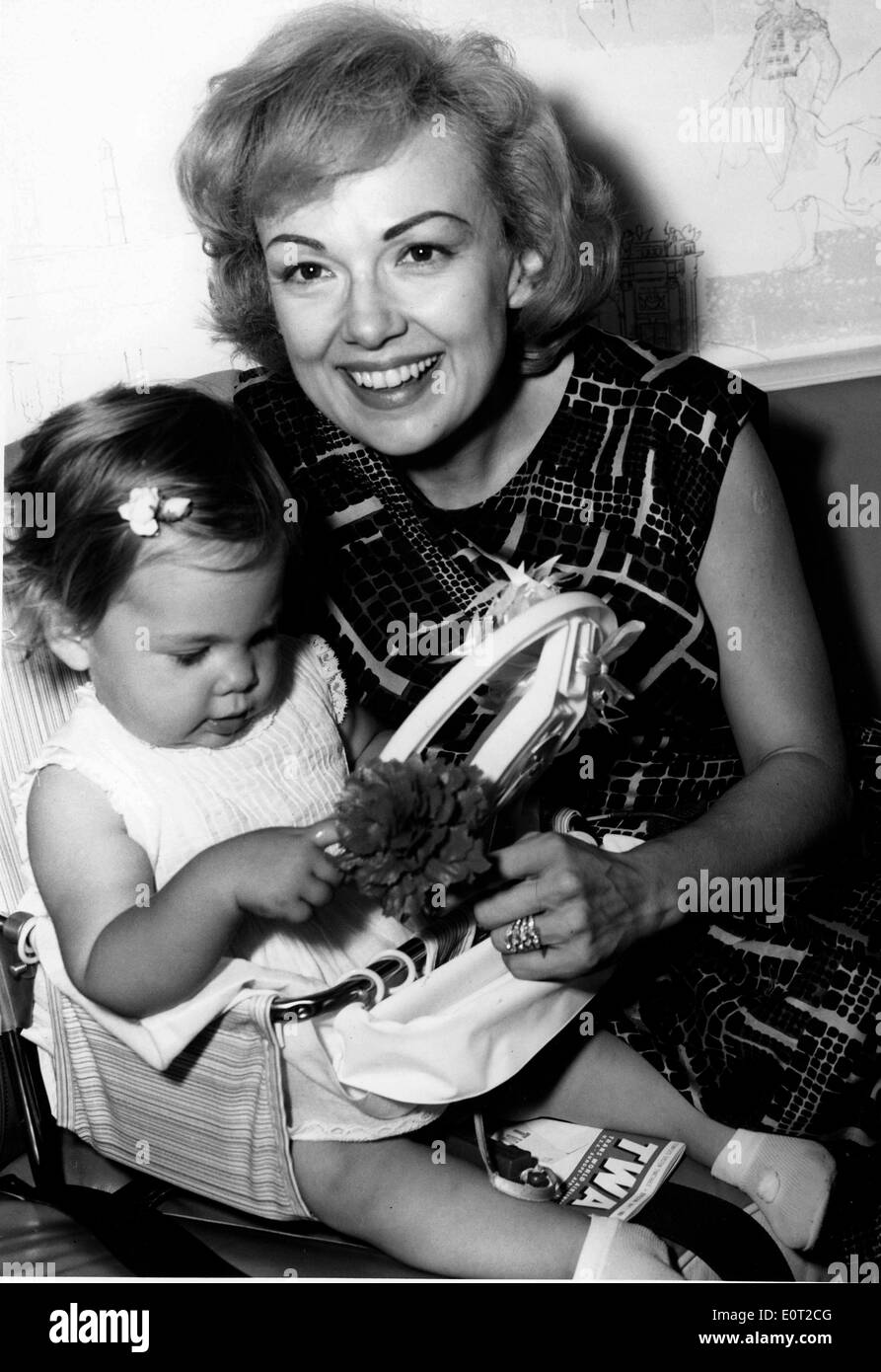 Jul 08, 1960 - New York, New York, U.S. - Actress and singer EDIE ADAMS, the blonde beauty who won a Tony Award for bringing Daisy Mae to life on Broadway and who played the television foil to her husband, comedian Ernie Kovacs, has died. She was 81. Edie Adams, seen here in 1963, became most famous for her role in a cigar commercial. Adams died Wednesday in a Los Angeles hospital from pneumonia and cancer Caption: Lovely actress Edie Adams playfully amuses her one year old daughter MIA KOVAC prior to winging their way via TWA's Superjet to their home in Los Angeles. Stock Photo