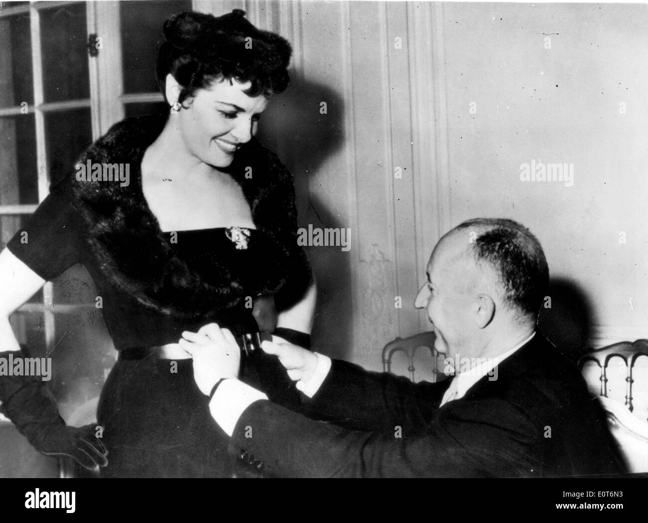Christian Dior fitting a woman in a dress Stock Photo
