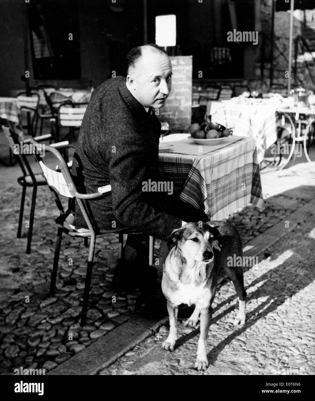 Fashion designer Christian Dior at a cafe with his dog Stock Photo