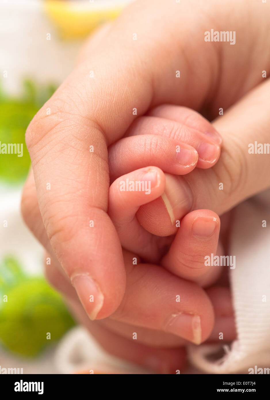Babyhand umfasst Daumen - baby holding mother's finger Stock Photo