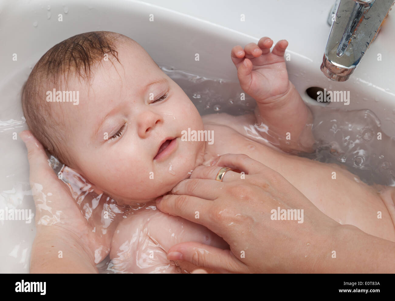 Baby wird gebadet - Baby bath Stock Photo