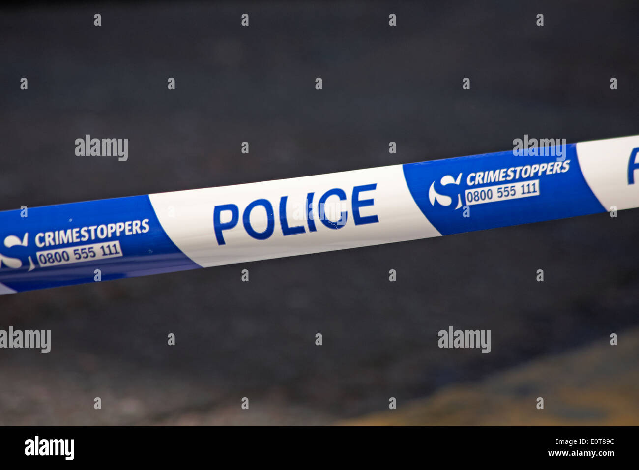 Police crimestoppers tape to cordon area for crime scene Stock Photo