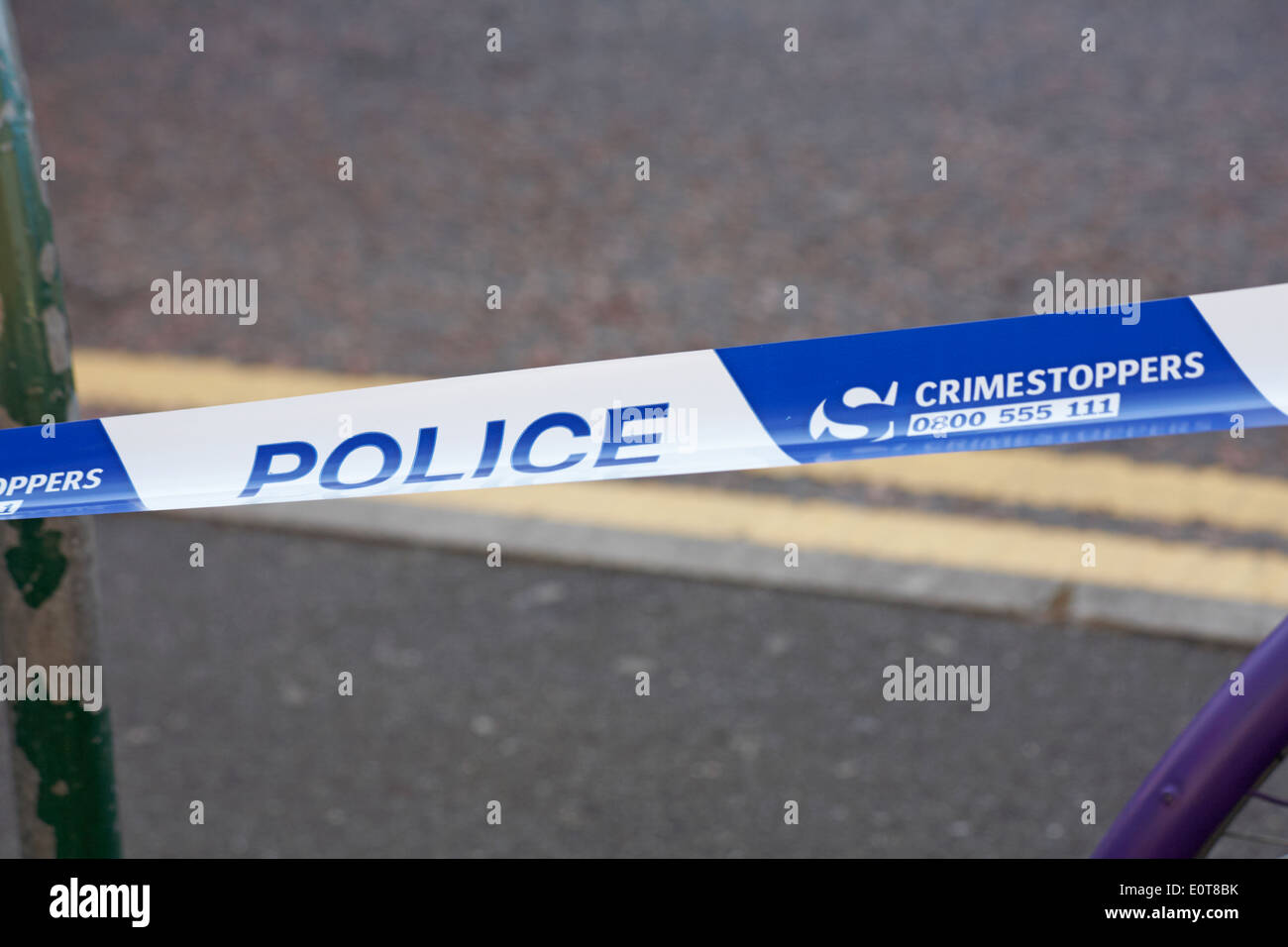 Police crimestoppers tape to cordon area for crime scene incident Stock Photo