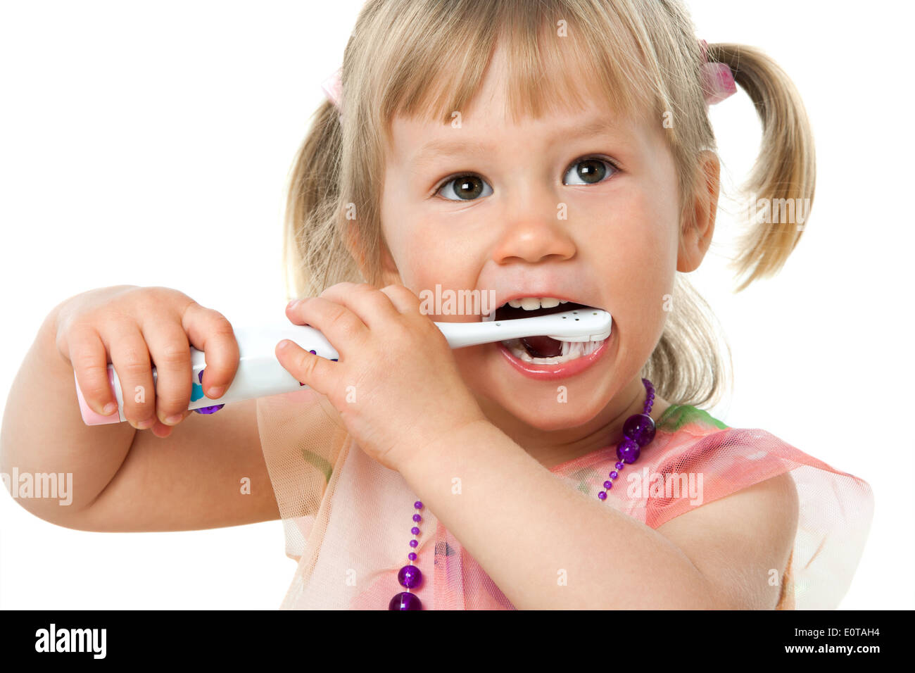 Close up portrait of little girl brushing teeth.Isolated on white background. Stock Photo