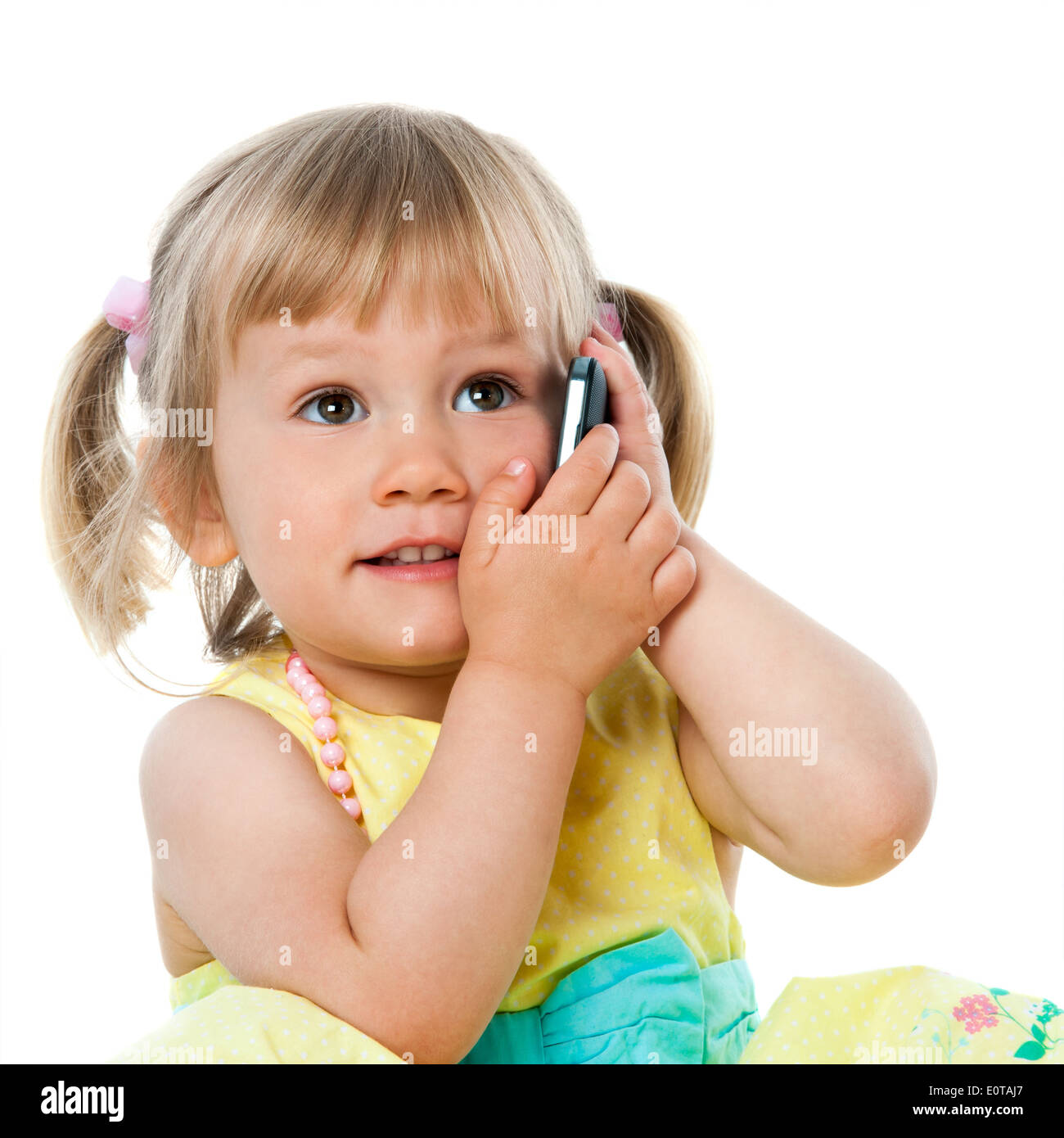 Close up portrait of cute little girl talking on cell phone.Isolated on white. Stock Photo