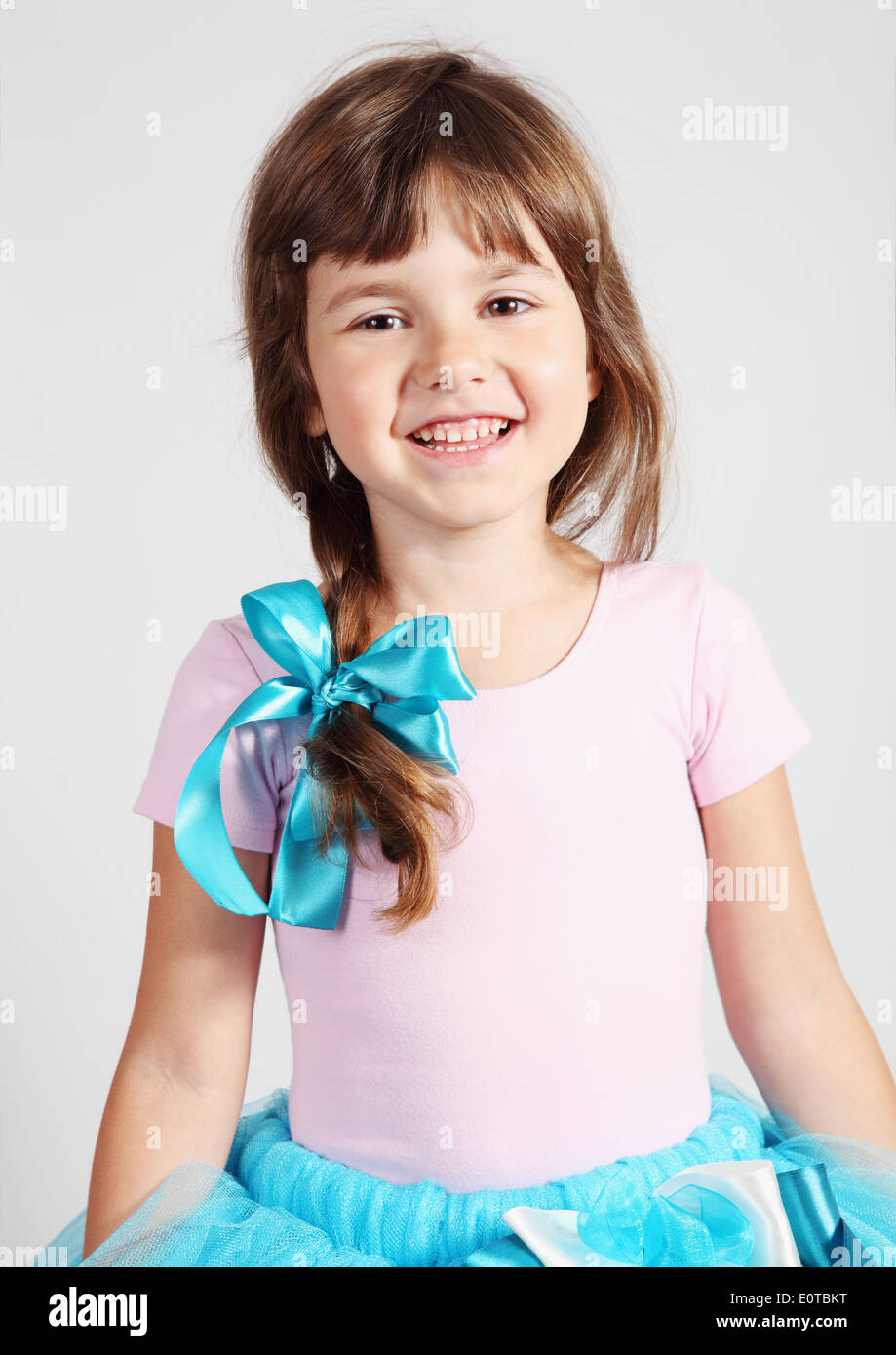 Little Girl Smiling Portrait Studio Shot over Gray Stock Photo