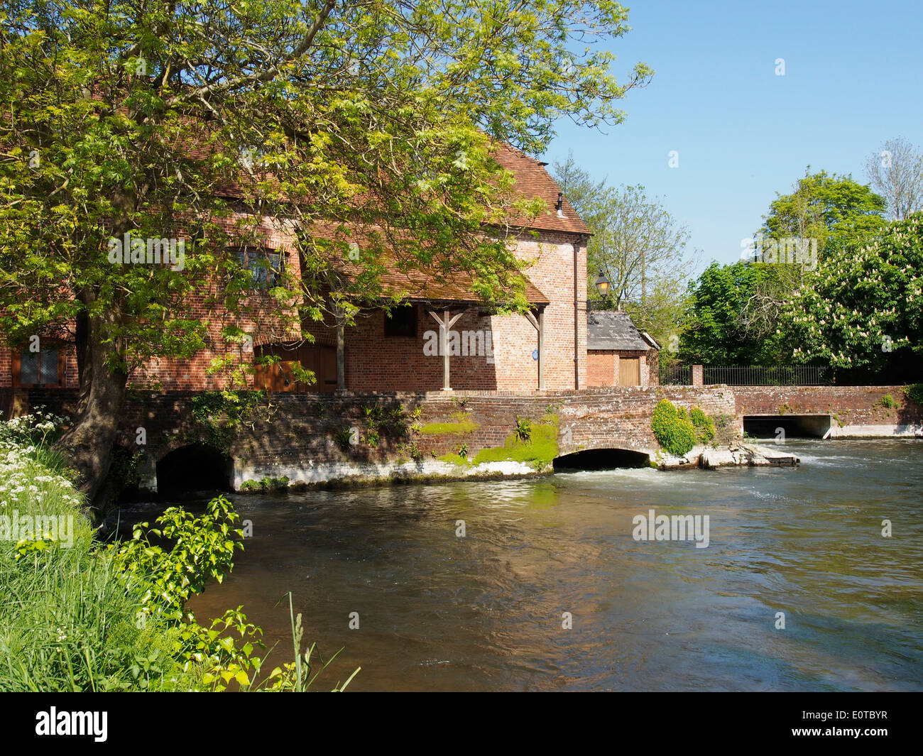 Sadler's Mill, a former water mill and salmon leap on a picturesque section of the River Test, Romsey in Hampshire. Stock Photo