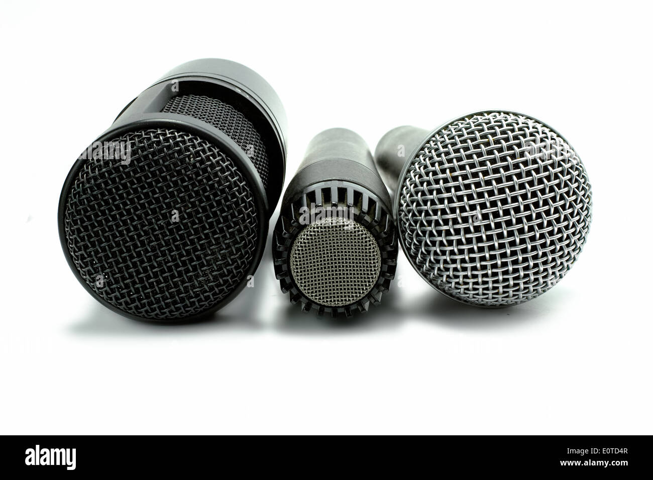 one condenser microphone and two dynamic microphones, isolated on white background Stock Photo