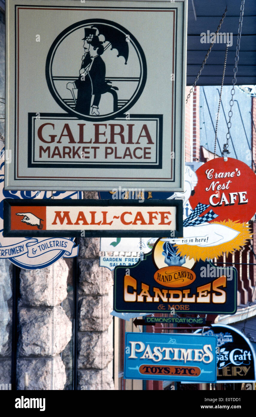 Colorful signs call attention to the many shops and restaurants along Spring Street in quaint Eureka Springs, a charming Ozarks town in Arkansas, USA. Stock Photo