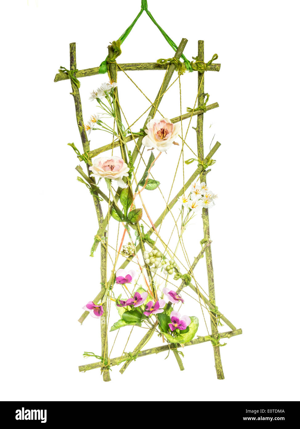 Isolated spring deco a trellis with artificial flowers Stock Photo