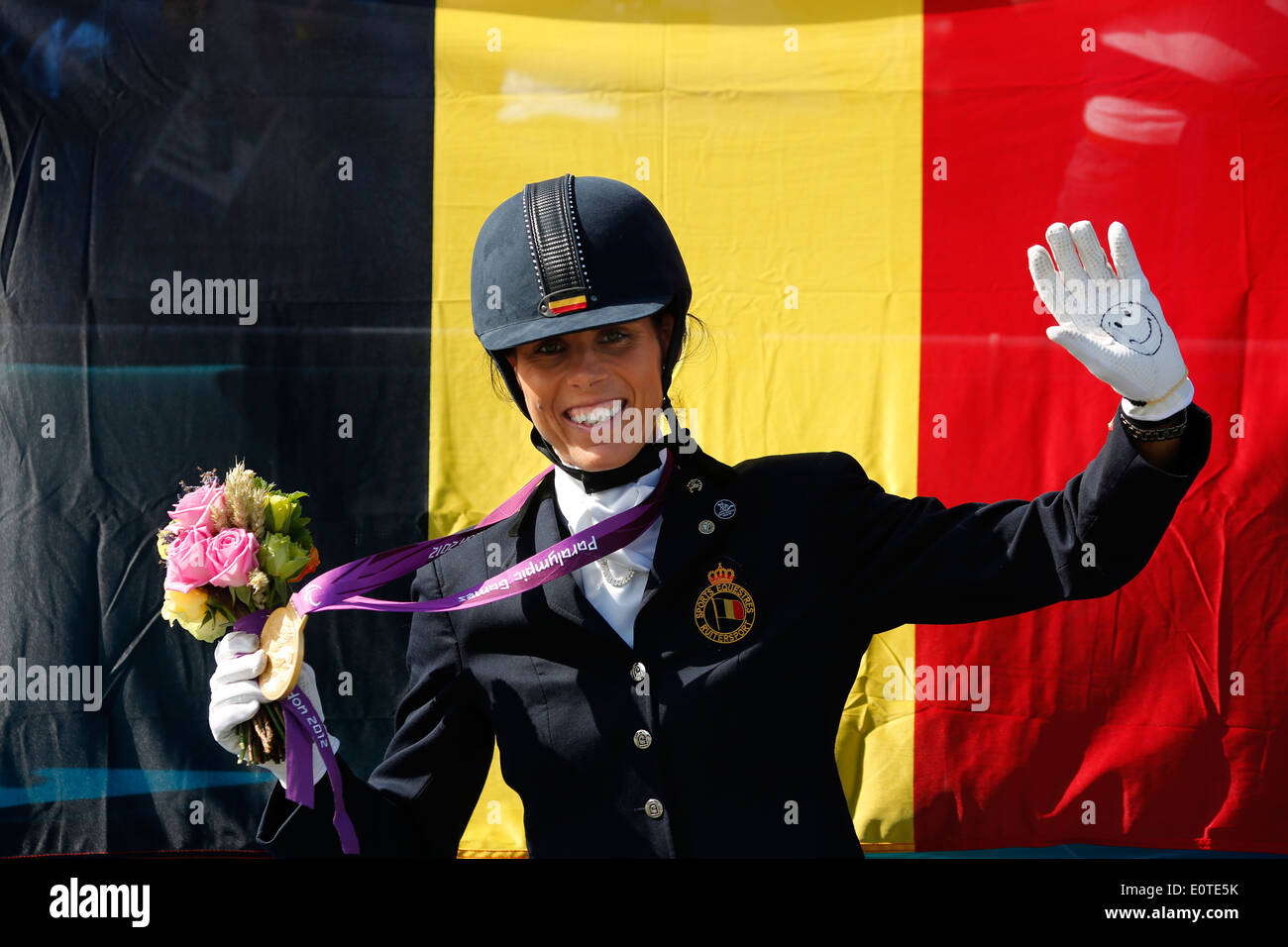 Michele George of Belgium celebrates winning the gold medal in the Equestrian Dressage Individual Freestyle Test - Grade IV at Greenwich park during the London 2012 Paralympic Games, London, Britain, 04 September 2012. Stock Photo