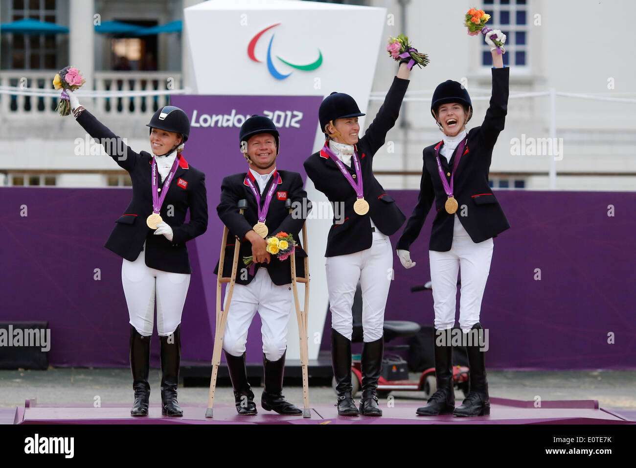 Britain's Equestrian Dressage team champions celebrate on the podium with their gold medals at Greenwich Park during the London 2012 Paralympic Games in London, Britain, 04 September 2012. Stock Photo