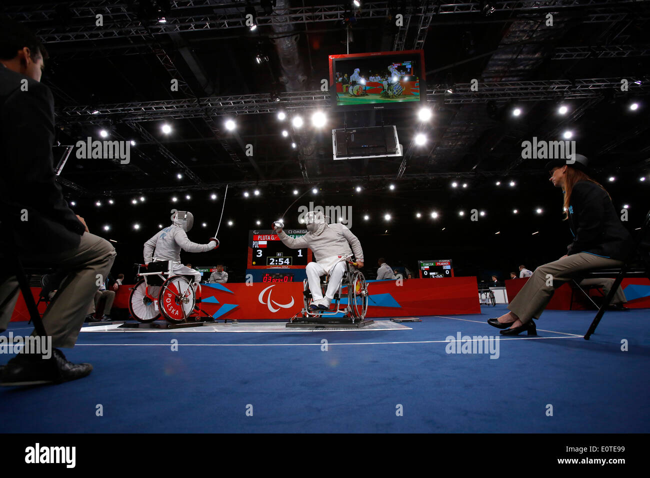Grzegorz Pluta of Poland (L) competes against Carlos Soler Marquez of Spain during the Men's Individual Sabre - Category B wheelchair fencing at the Excel Center during the London 2012 Paralympic Games in London, Britain, 06 September 2012. Pluta won 5-2 Stock Photo
