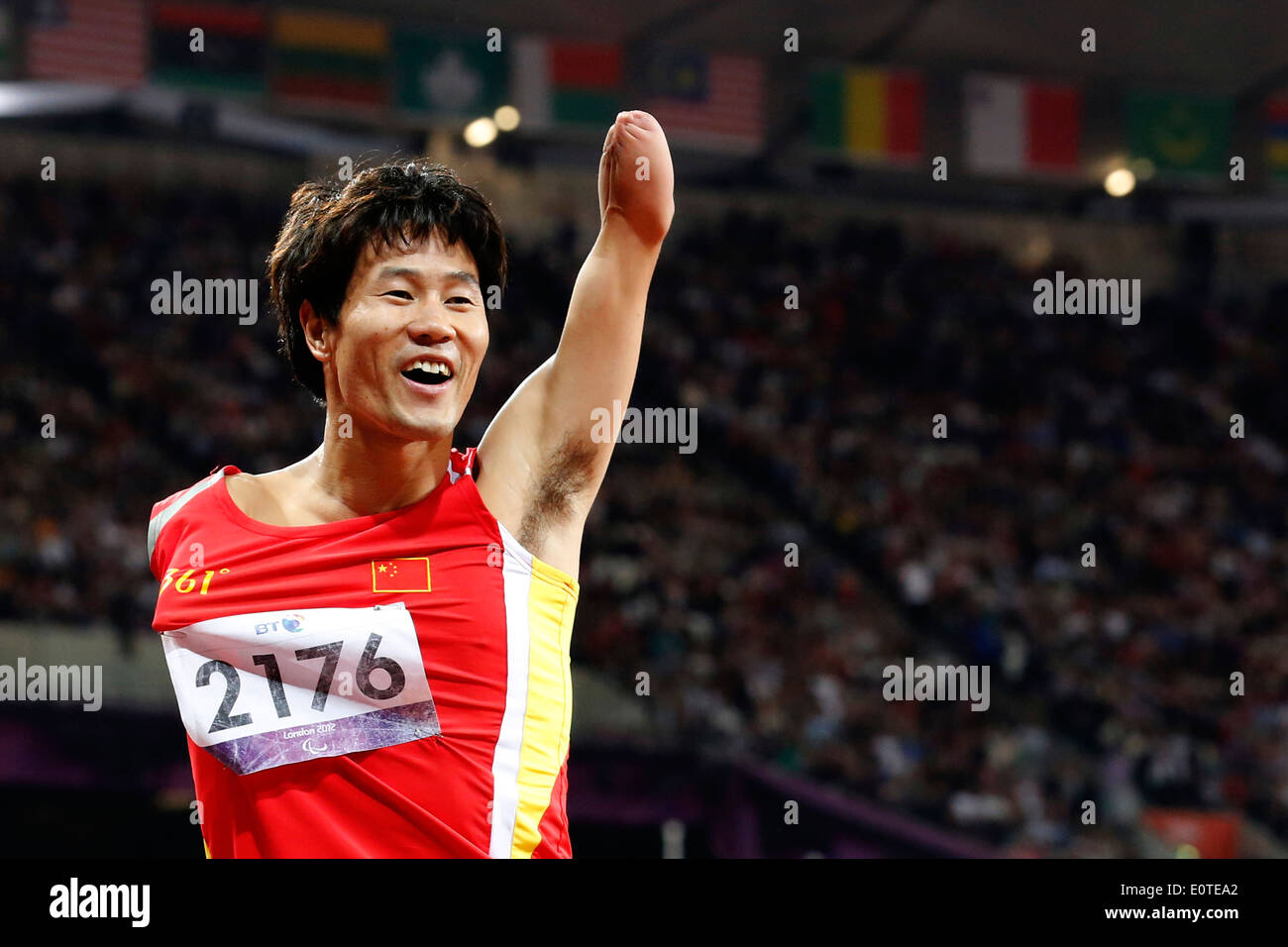 Xu Zhao of China celebrates winning gold following the men's 100m - T46 final at the Olympic Stadium during the London 2012 Paralympic Games, London, Britain, 06 September 2012. Stock Photo