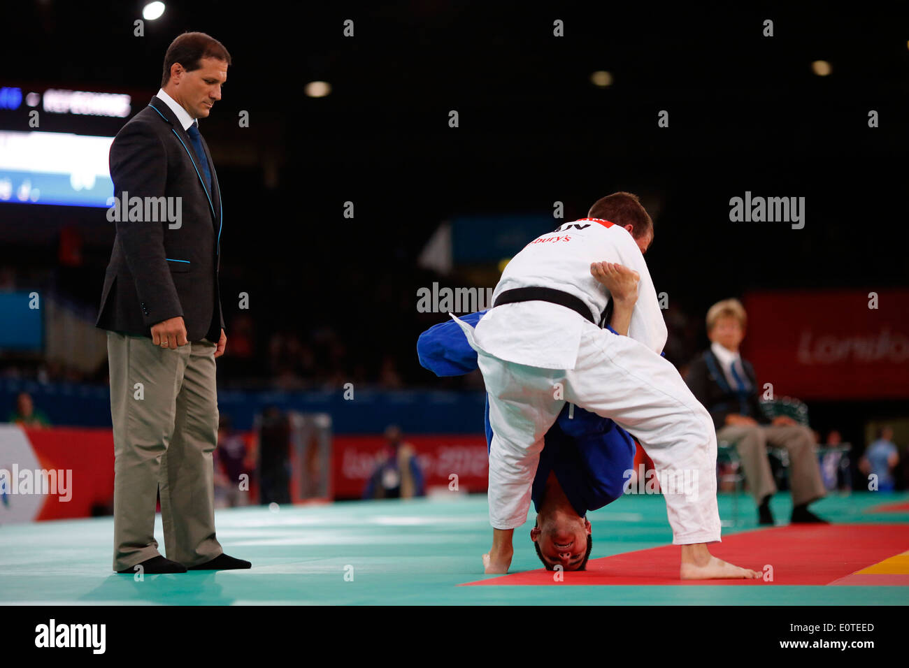 Justin Karn of Canada (white) fights against Juan Castellanos Of Colombia (blue) during the men's repechage 60kg London 2012 Paralympic Games Judo competition in London, Britain, 30 August 2012. Stock Photo