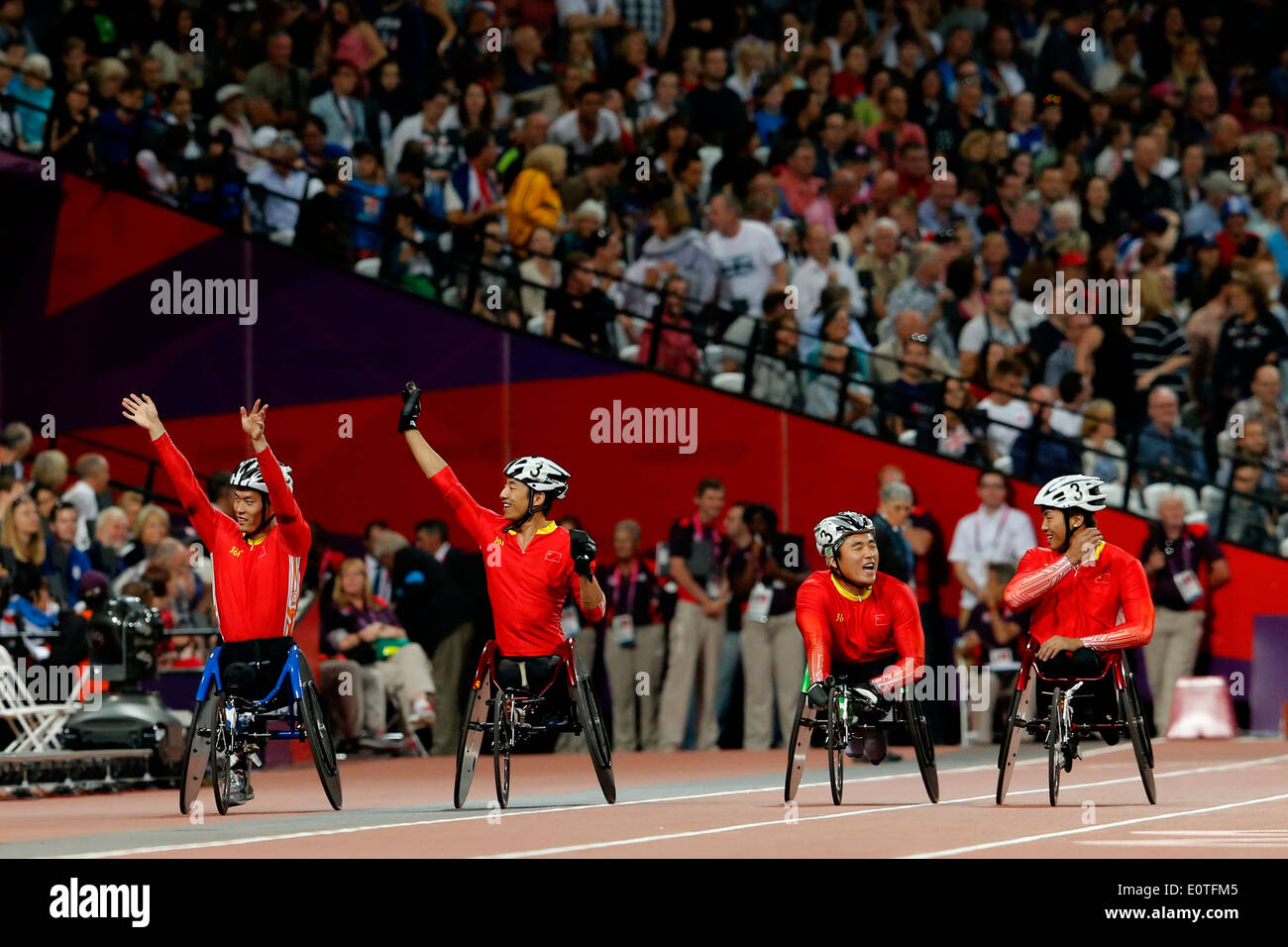 China's men's 4x400m Relay - T53/T54 team celebrate winning gold following the final at the Olympic Stadium during the London 2012 Paralympic Games, London, Britain, 08 September 2012. Stock Photo