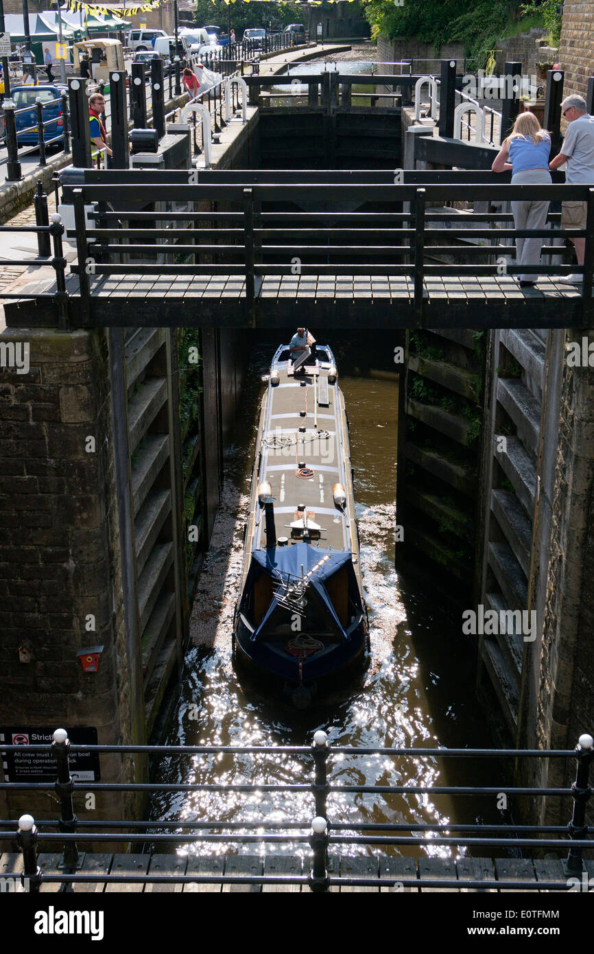 Narrowboat leaving Tuel Lane Lock (deepest lock in Britain), Sowerby Bridge, West Yorkshire Stock Photo