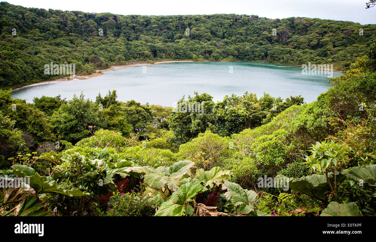Lagos Botos is a forest fringed emerald lake that fills an extinct crater near the active Poas volcano in central Costa Rica Stock Photo