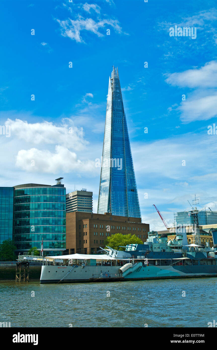 The Shard seen from the River Thames, with the warship museum HMS Belfast moored in the foreground, central London, England UK Stock Photo